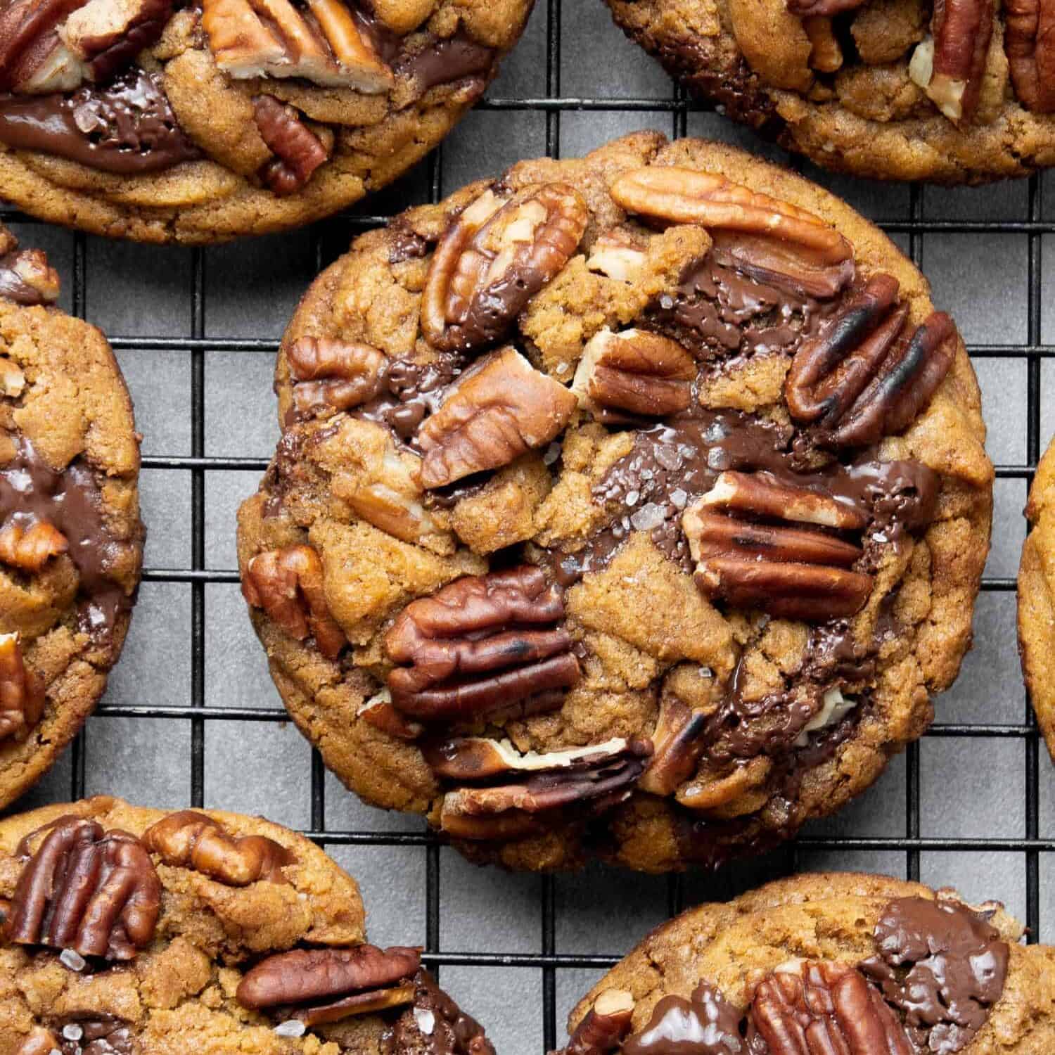 Pecan chocolate chip cookies on a cooling rack.