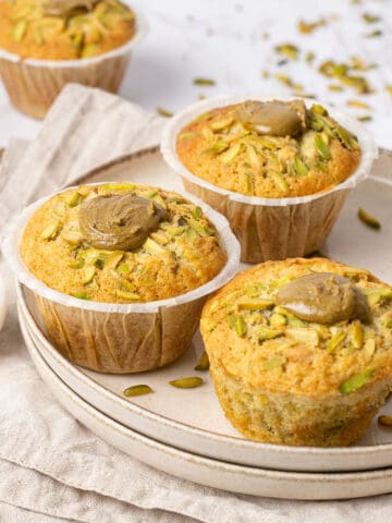 Pistachio muffin on a plate.