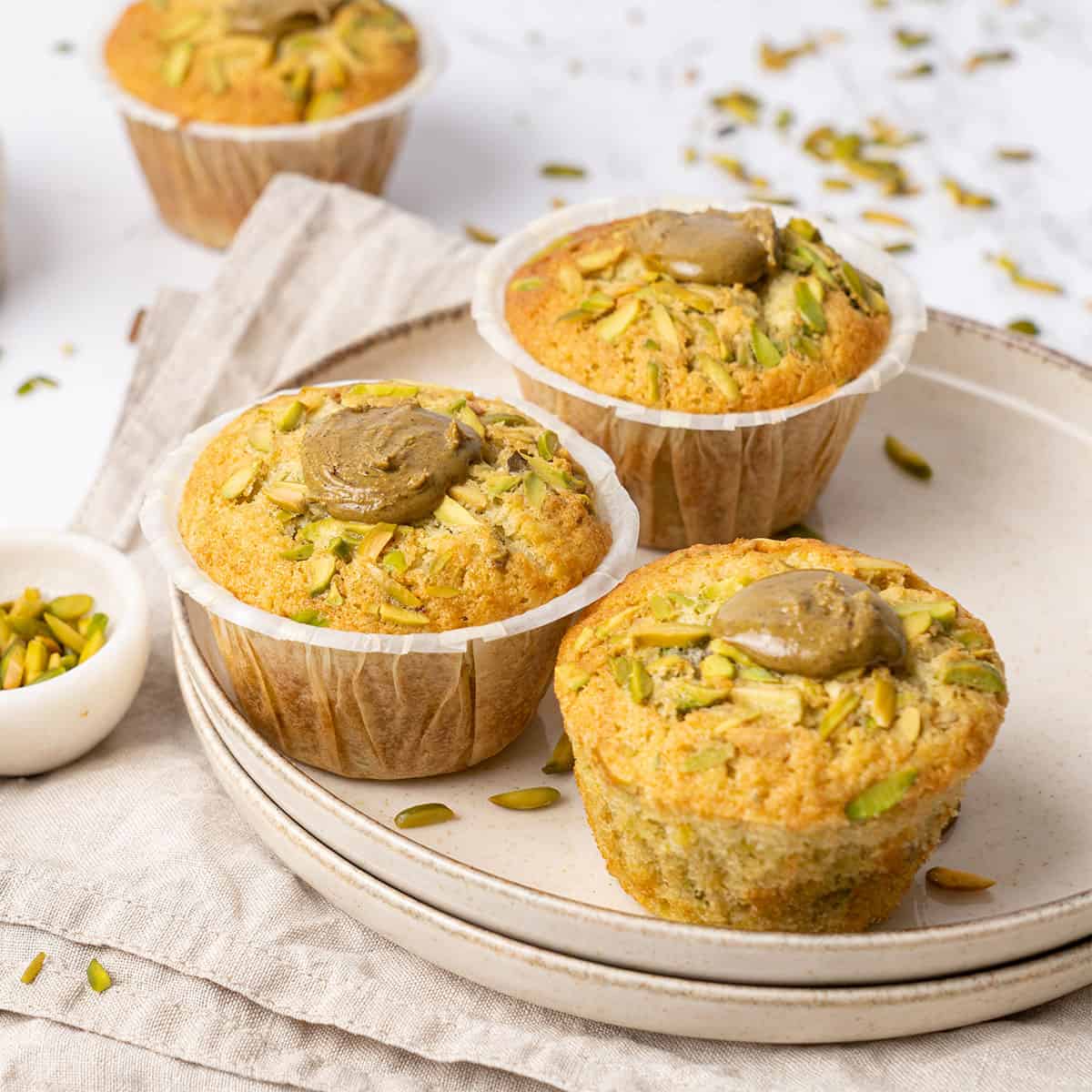 Pistachio muffin on a plate.