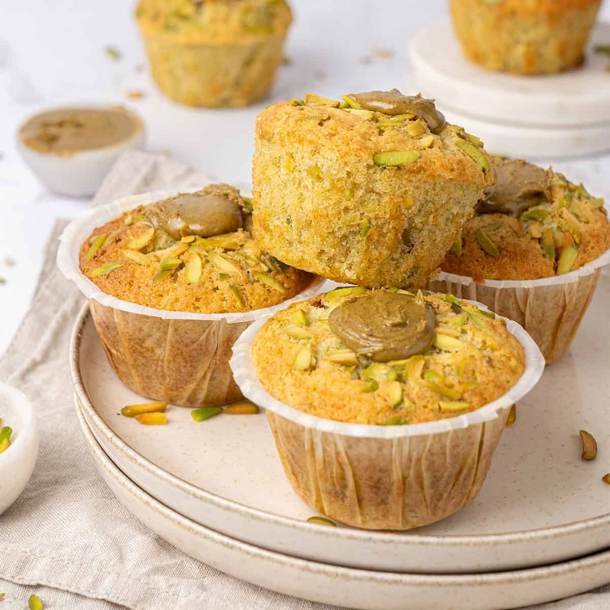 Pistachio muffin on a plate.