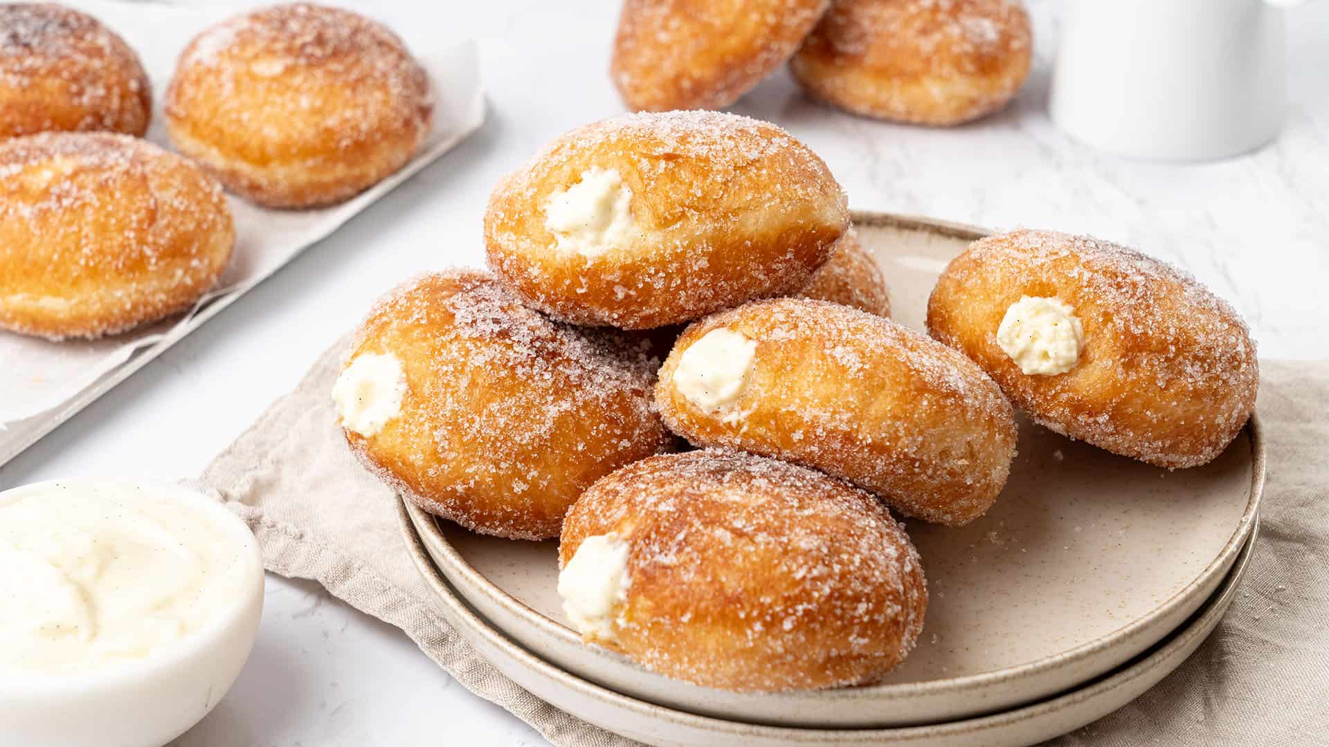 Bavarian cream donuts on a plate.