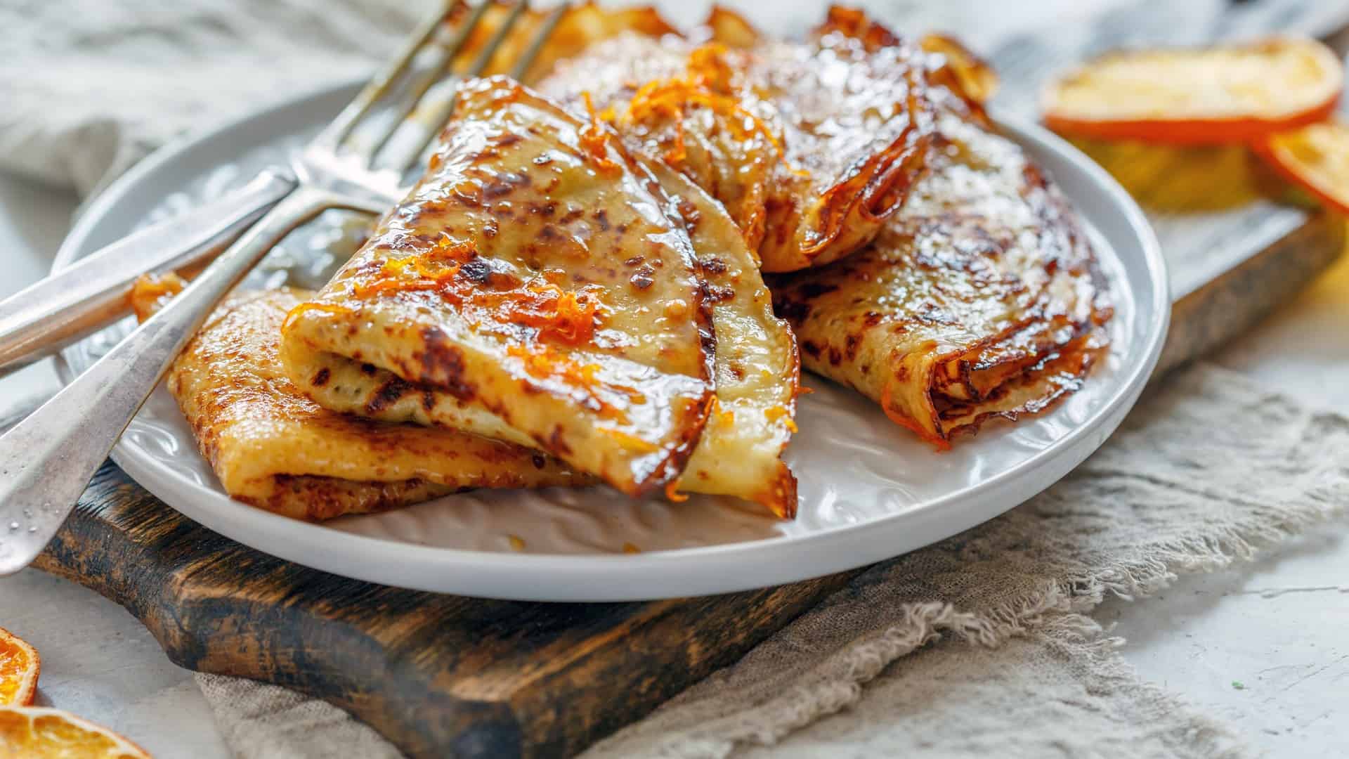 Orange crepes suzette on a white plate