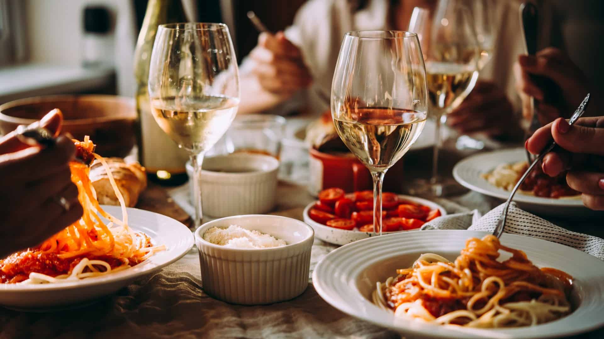 Italian restaurant table with pasta and wine