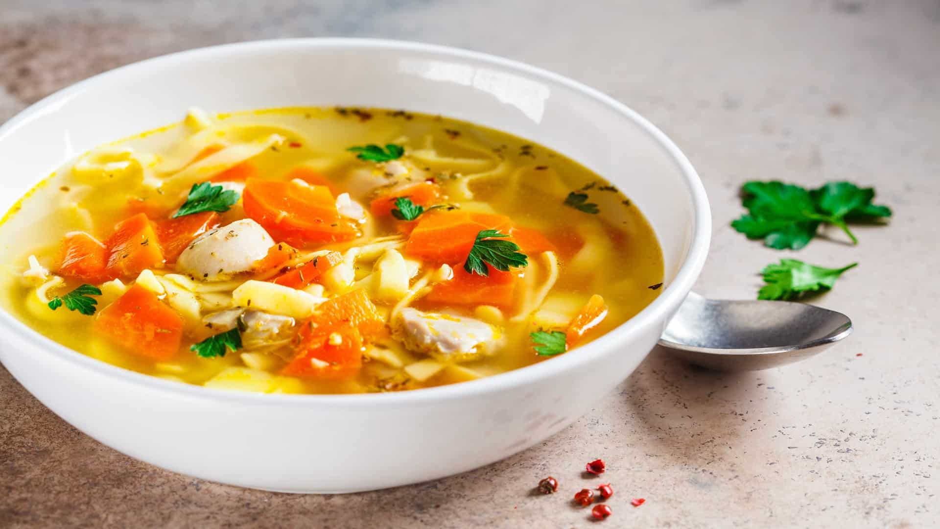 White bowl of homemade chicken noodle soup