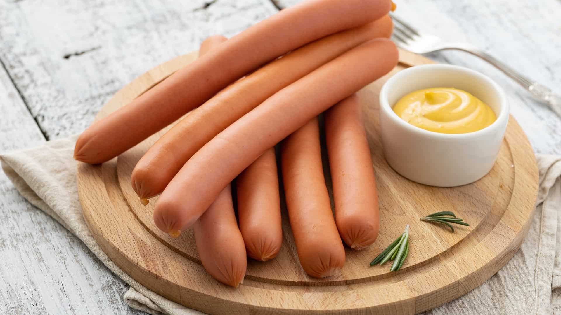 Vienna sausages on a plate with mustard