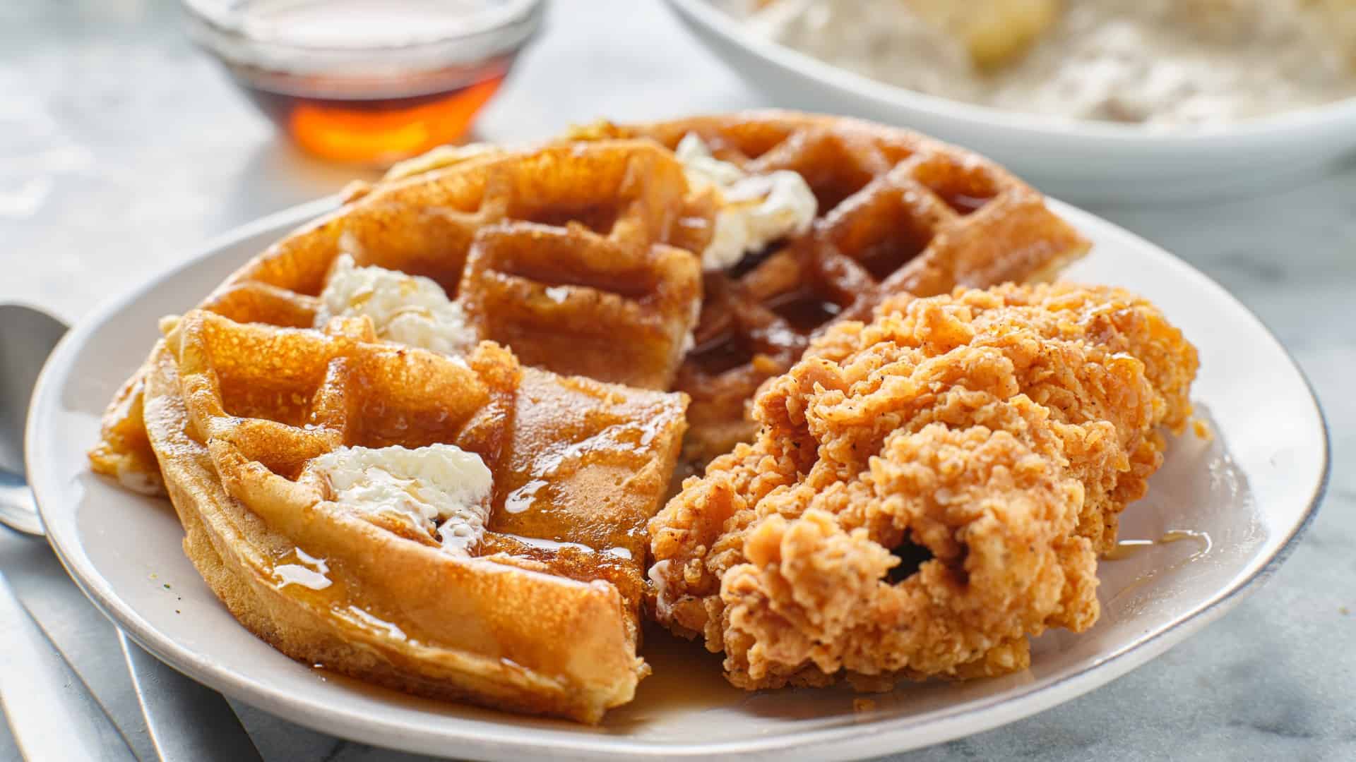Plate of chicken and waffles with syrup