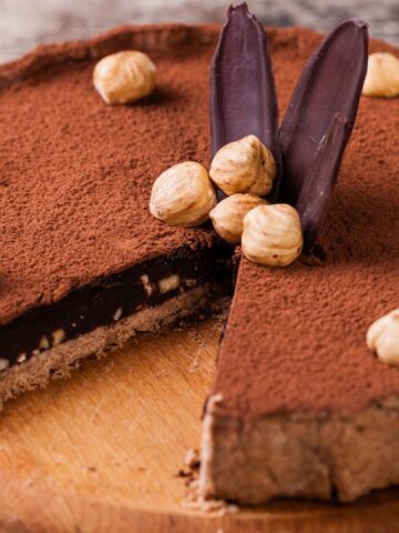 chocolate hazelnut tart with cocoa powder on top