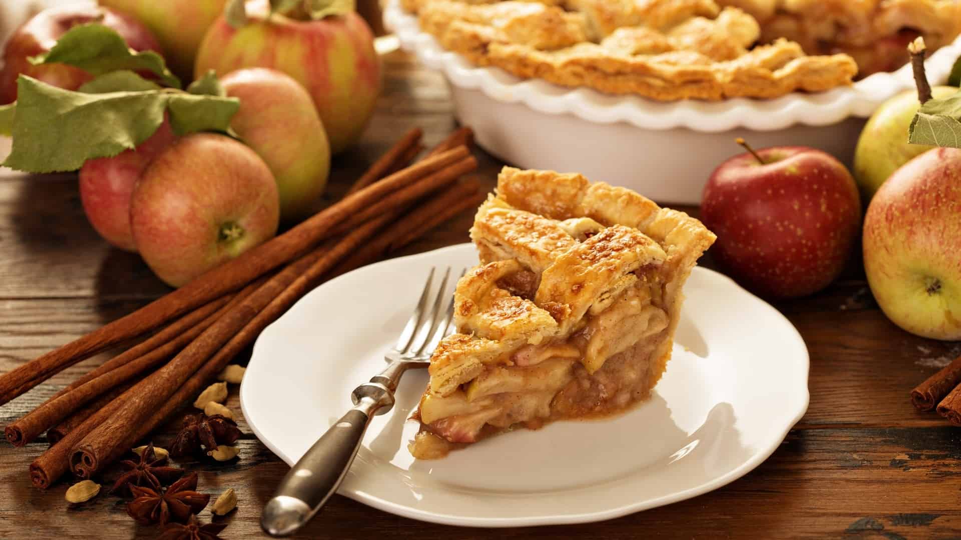Slice of homemade apple pie on a white plate