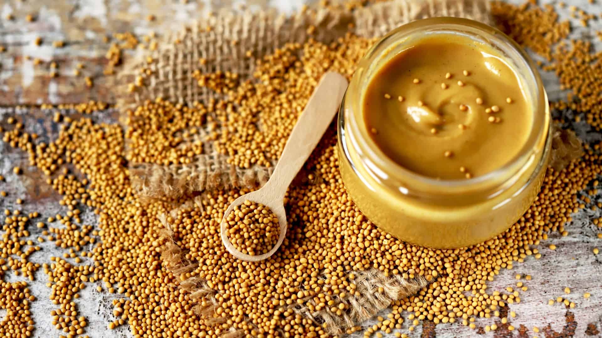 Mustard and mustard seeds on table