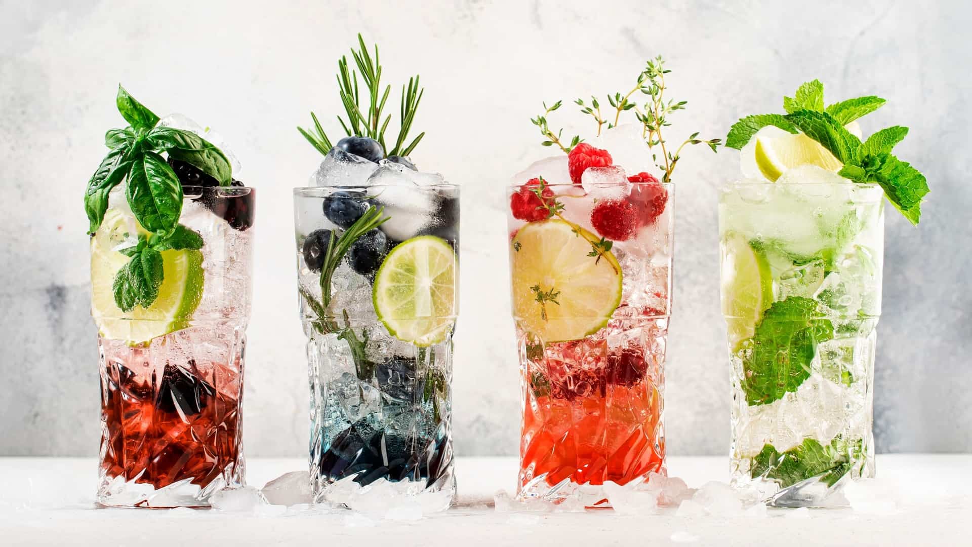 four mocktails with different fruits