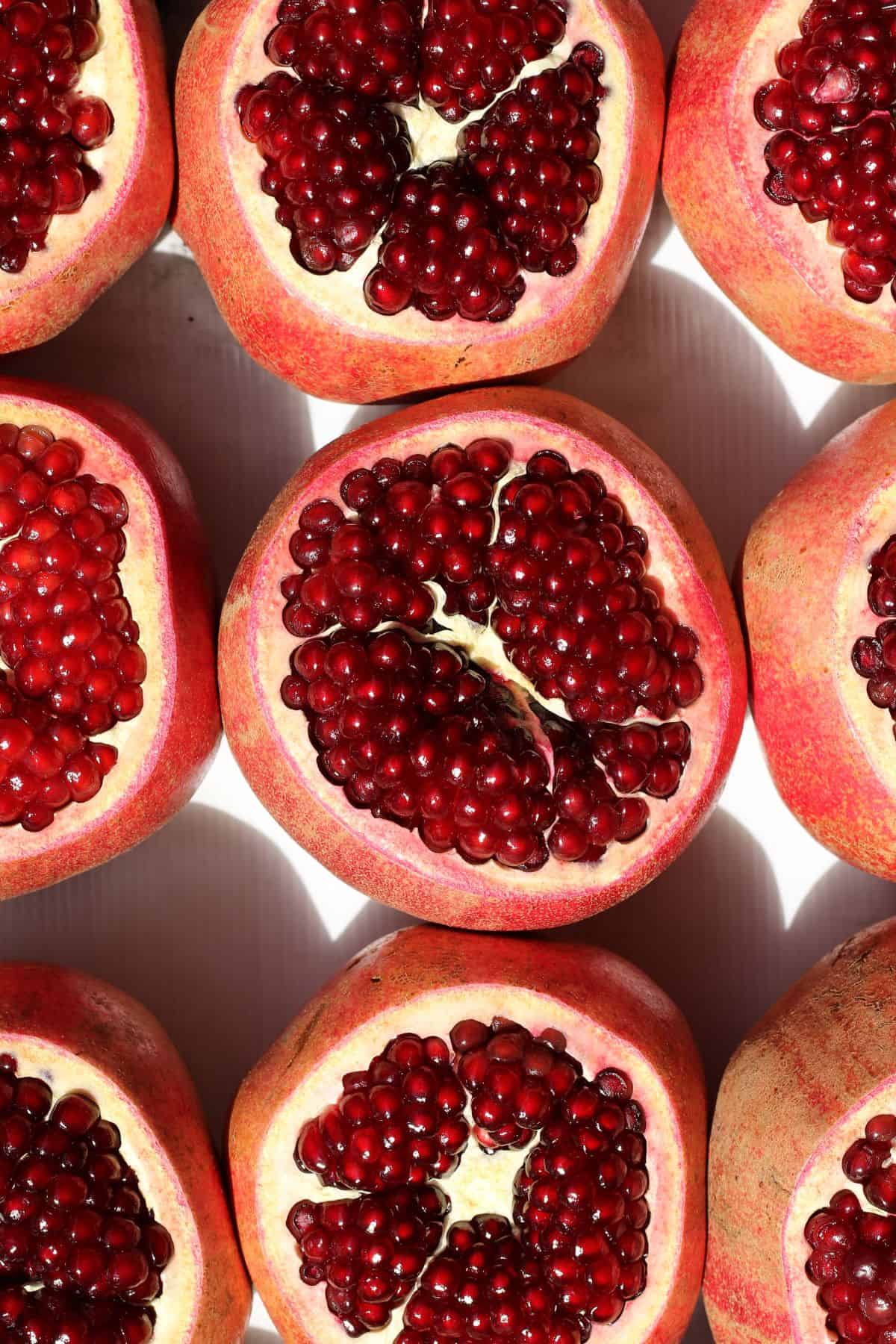 Pomegranates cut open to reveal the seeds inside. 