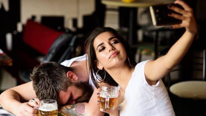 man passed out at a bar with attractive woman