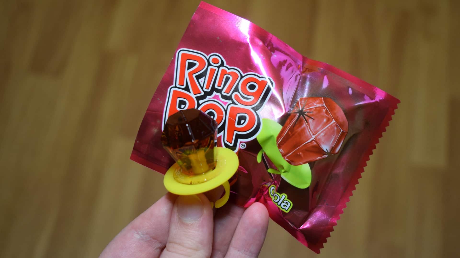Person holding pink ring pop