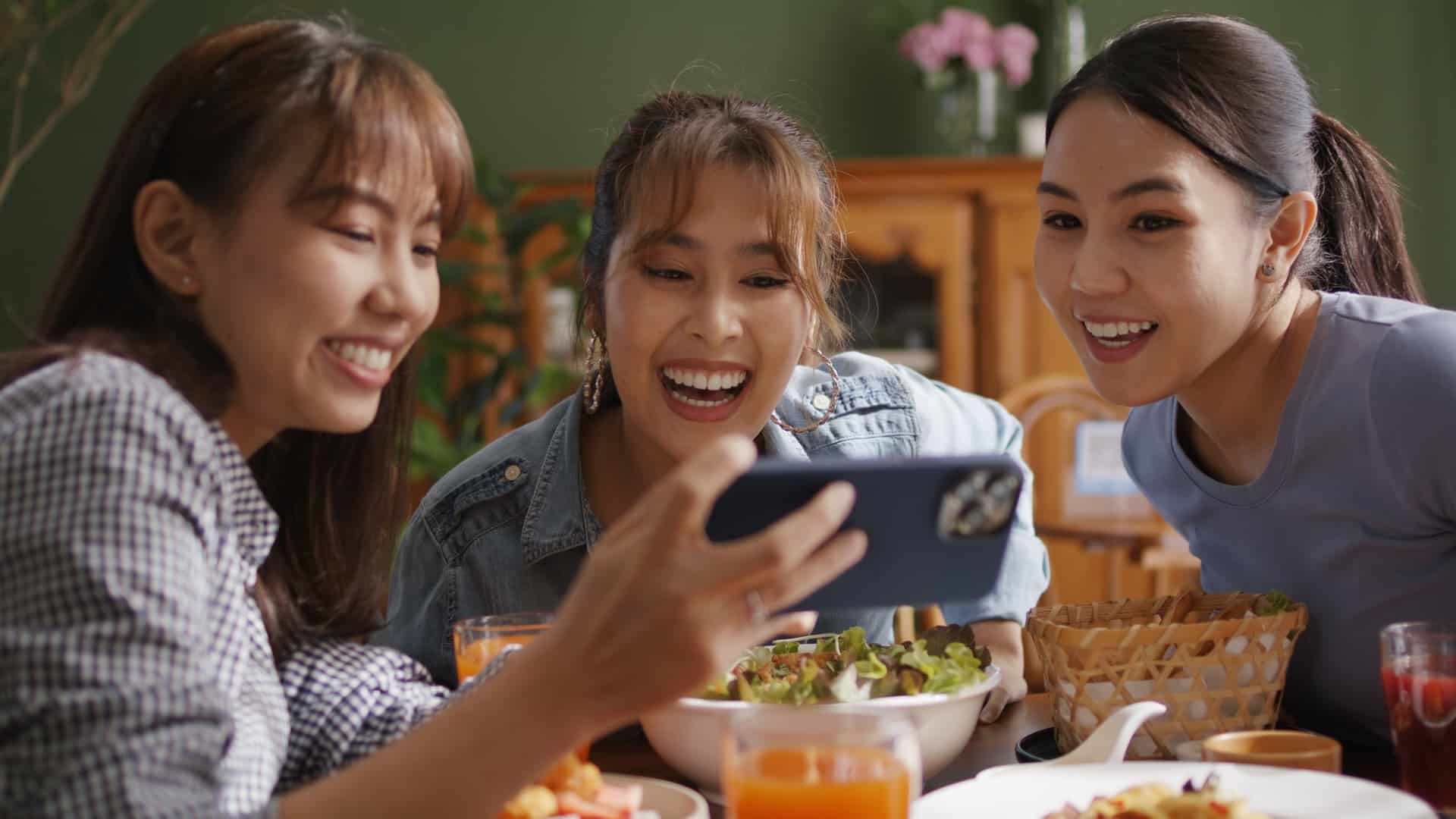 Women looking at phone and laughing