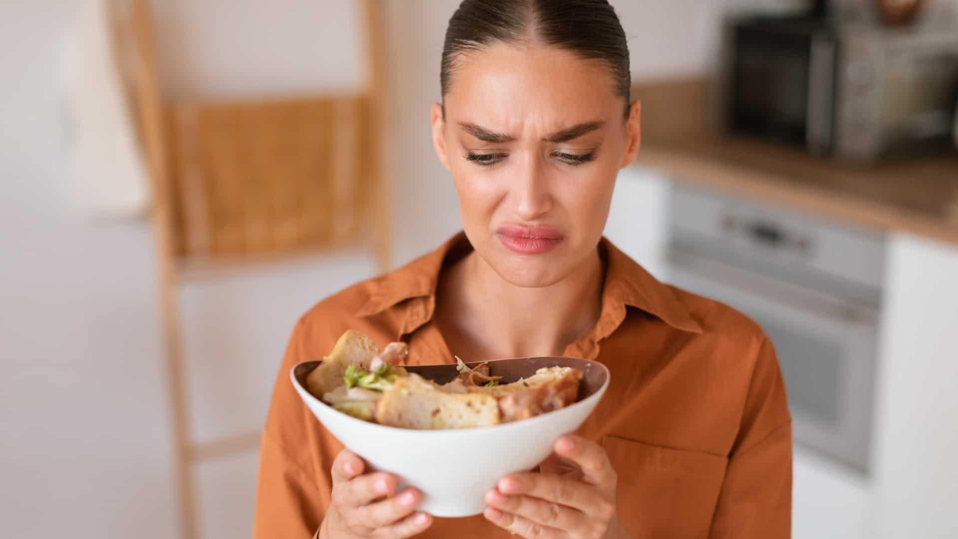 Woman looking at food in a gross way