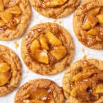 Apple pie cookies on a white baking sheet.