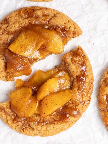 Apple pie cookies on a white baking sheet.