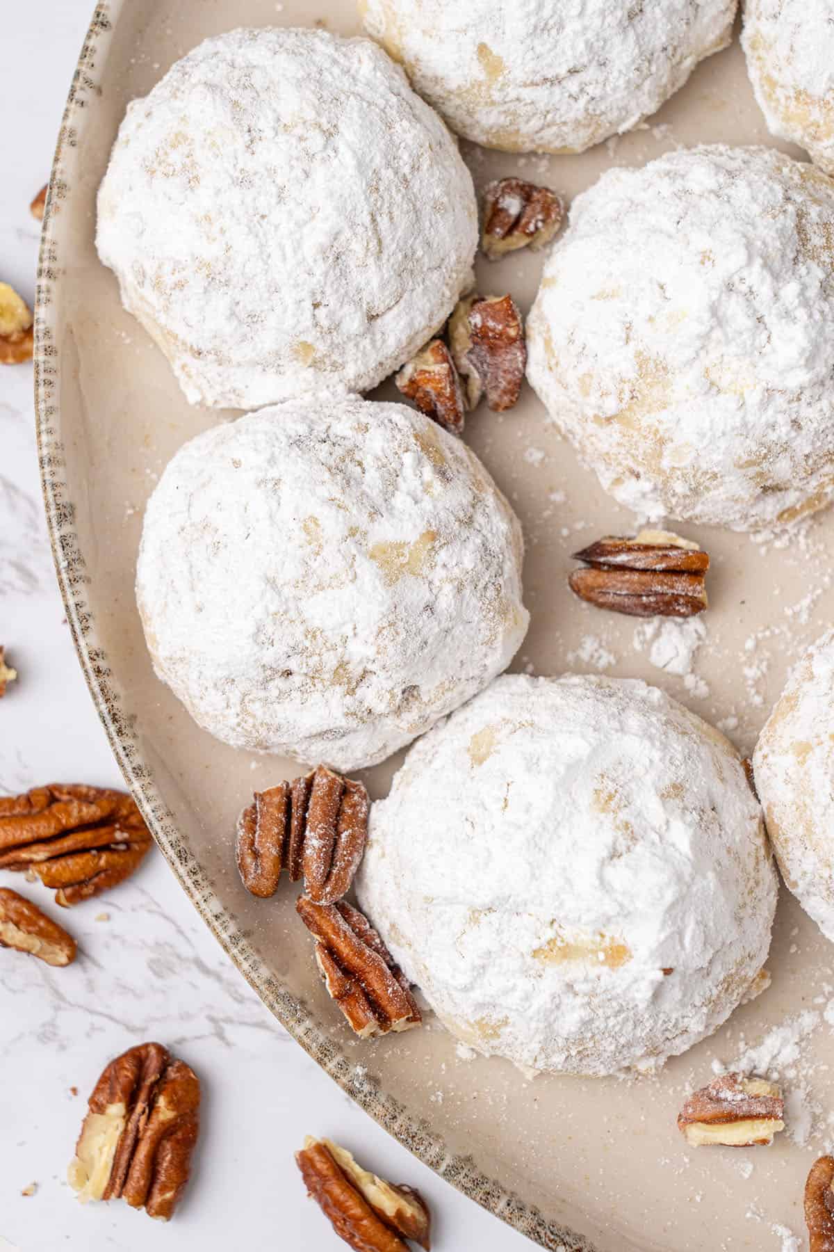 Pecan snowball cookies on a plate.