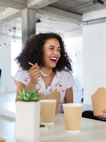 women having lunch at work and laughing