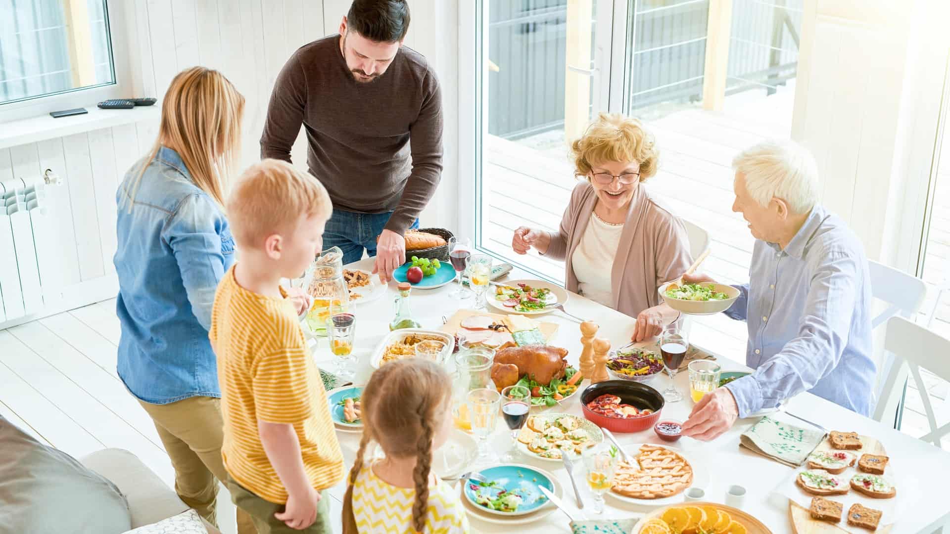 Family sitting down to eat a big meal