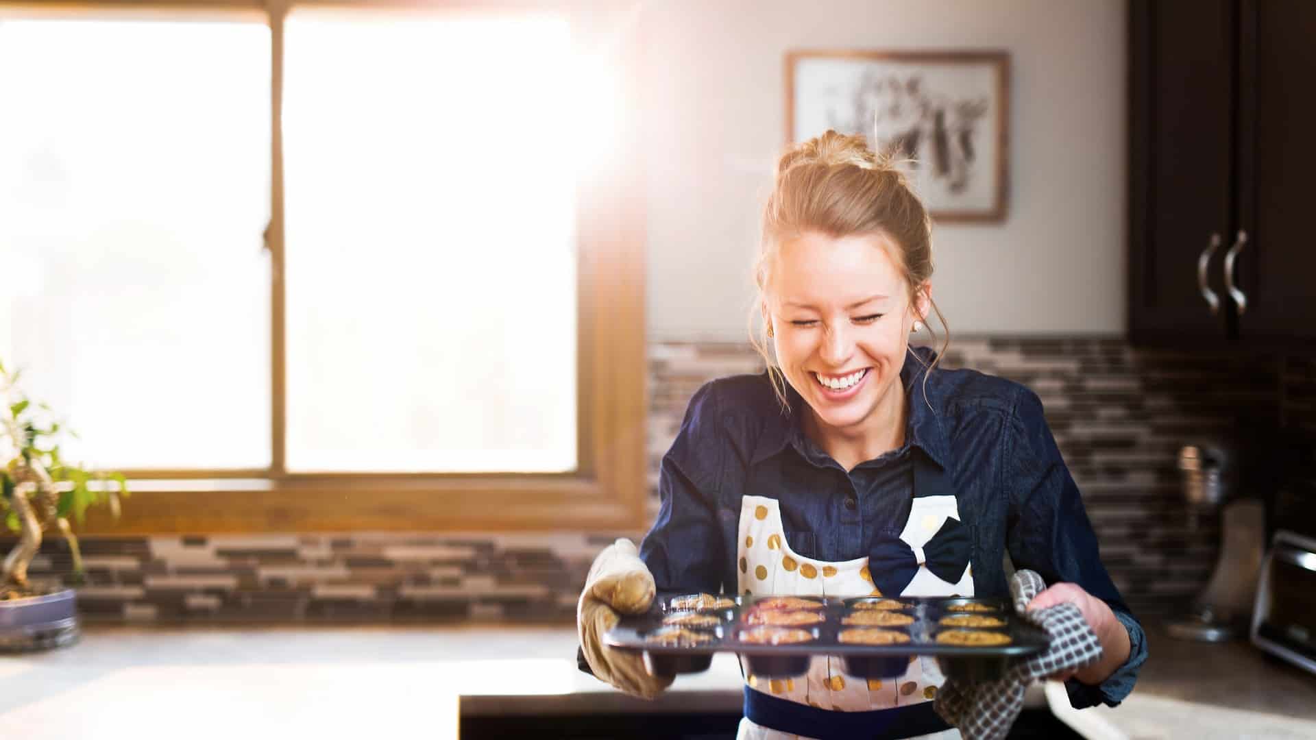 Woman happily baking cupcakes