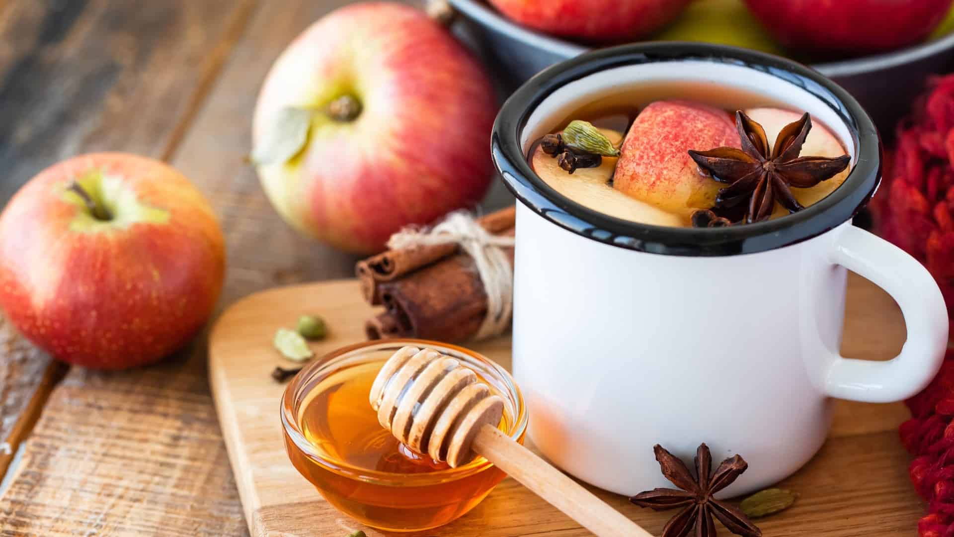 mug of apple cider with apples