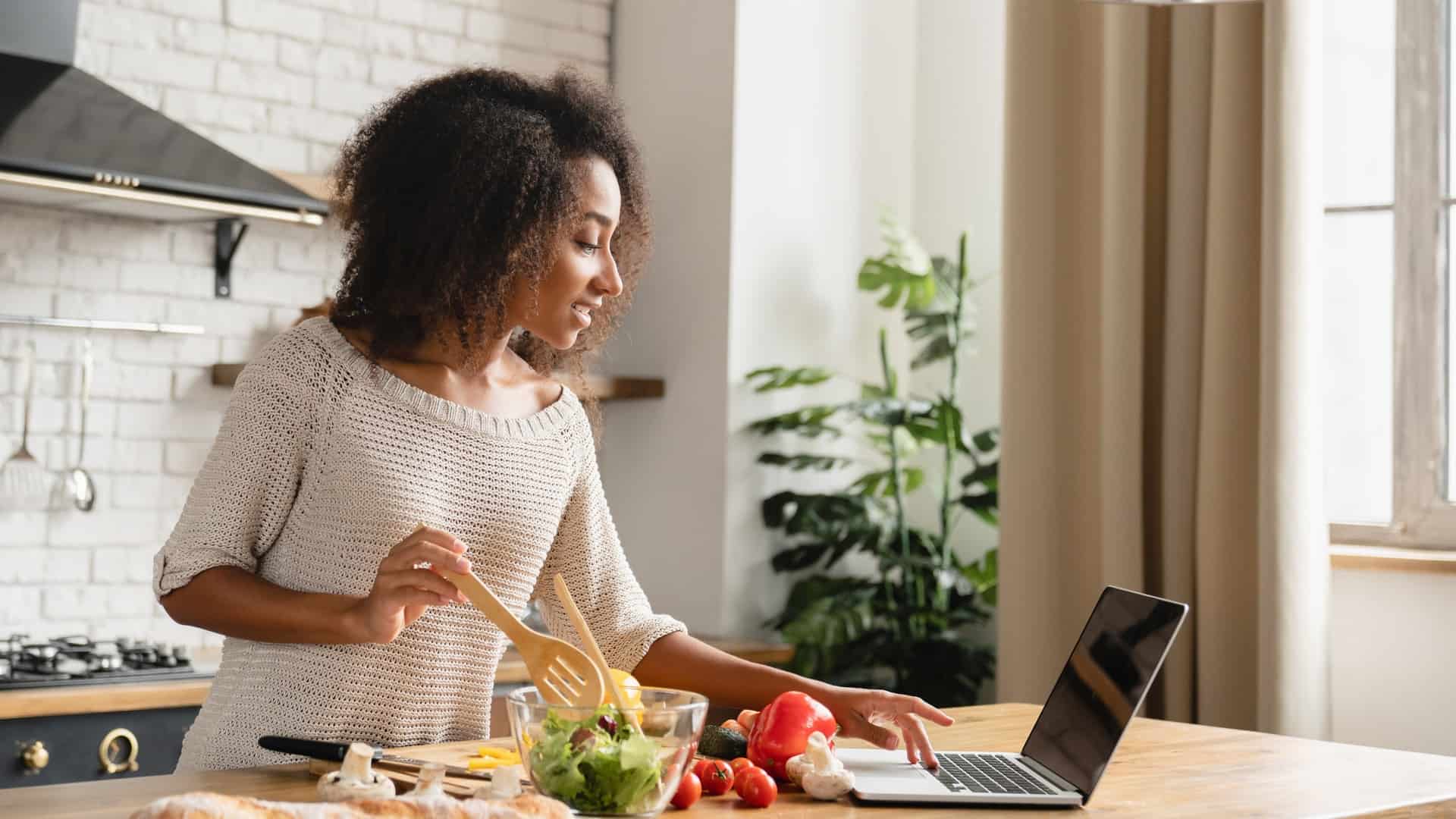Woman making a recipe with computer
