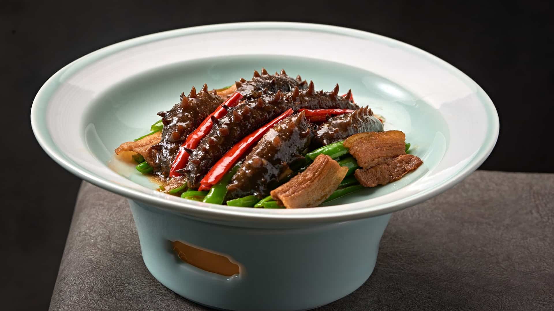 braised sea cucumbers in a white bowl