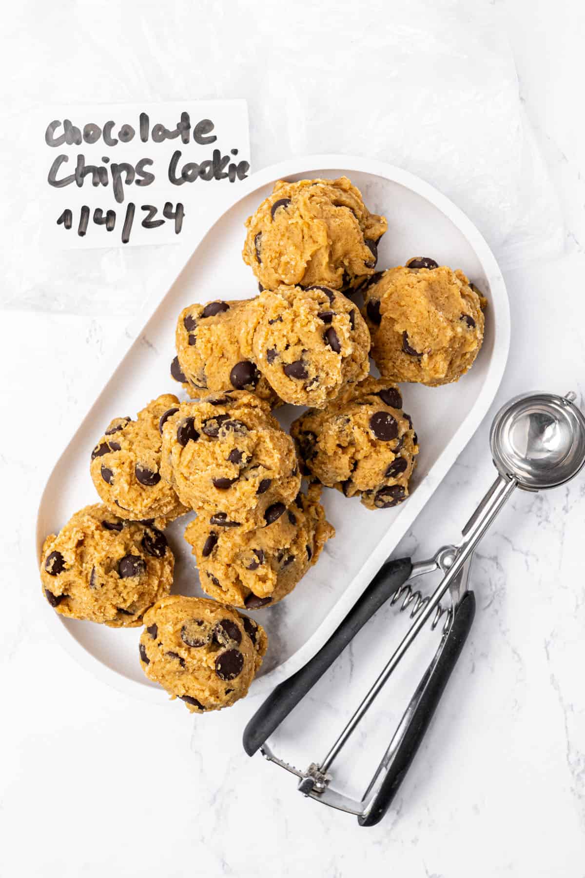 Cookie balls for freezing on a plate.