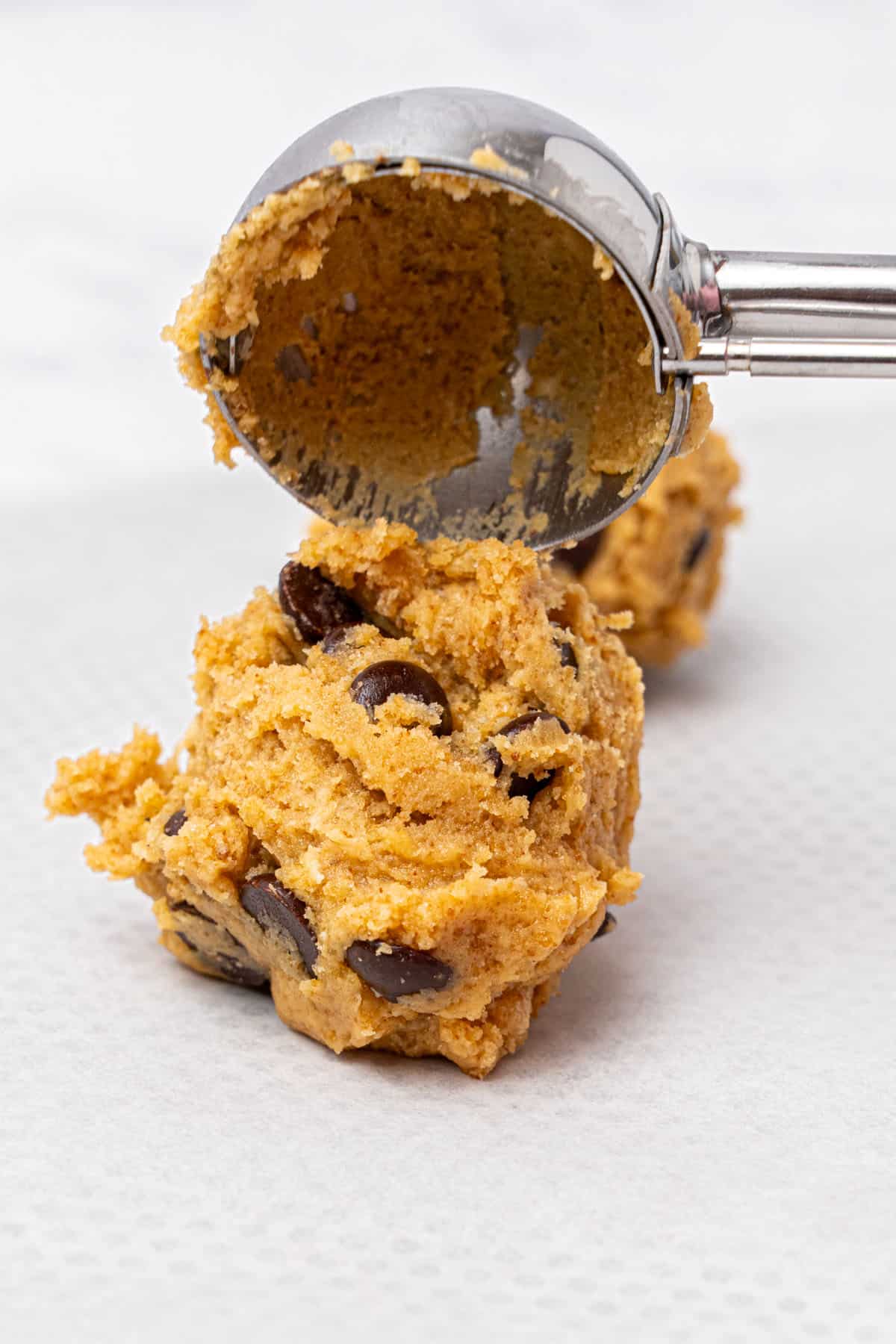 Making cookie balls with an ice cream scoop.
