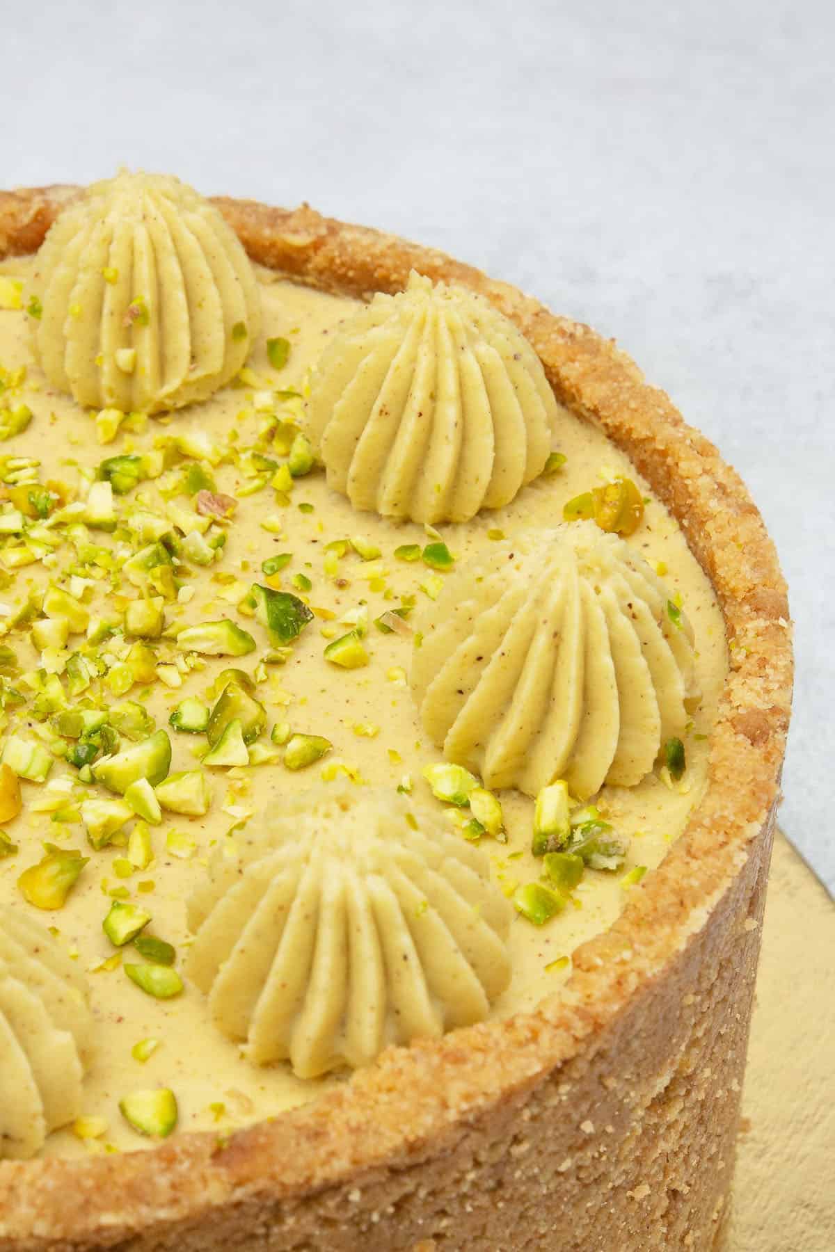 Pistachio cheesecake on a cake stand.