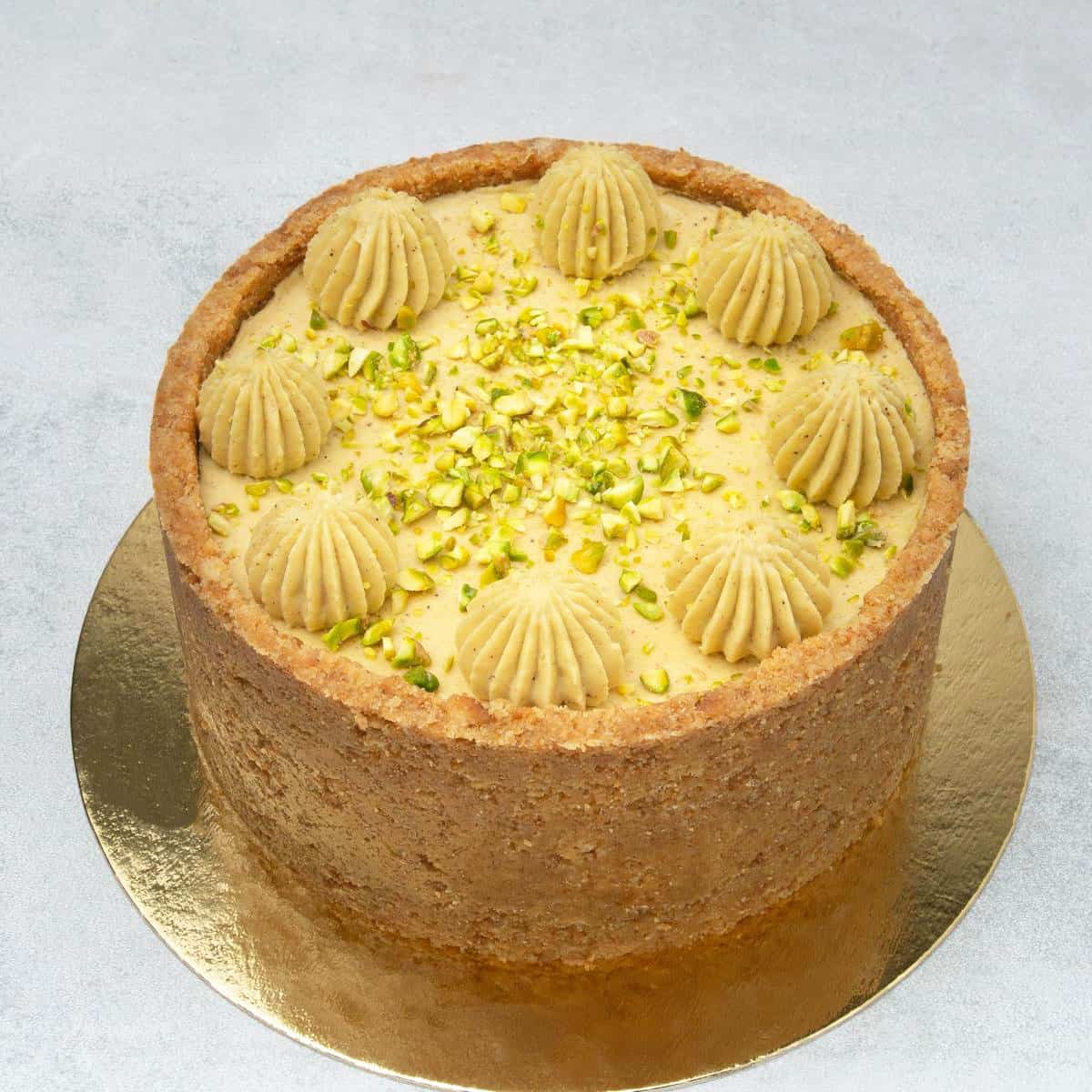 Pistachio cheesecake on a cake stand.