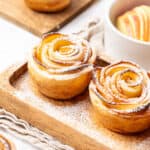 apple roses with puff pastry on a wooden tray.