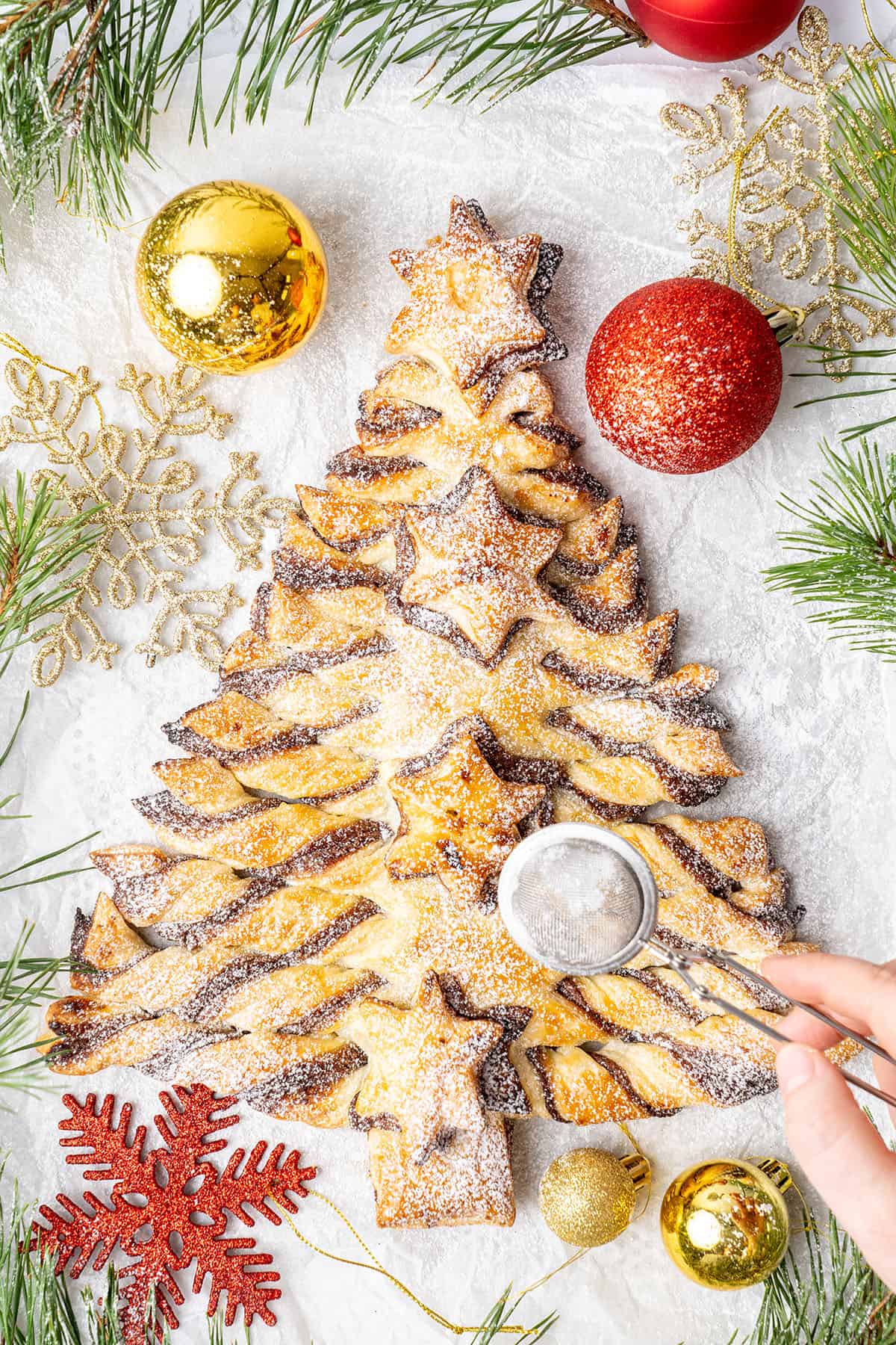 Nutella puff pastry Christmas tree in a baking paper.