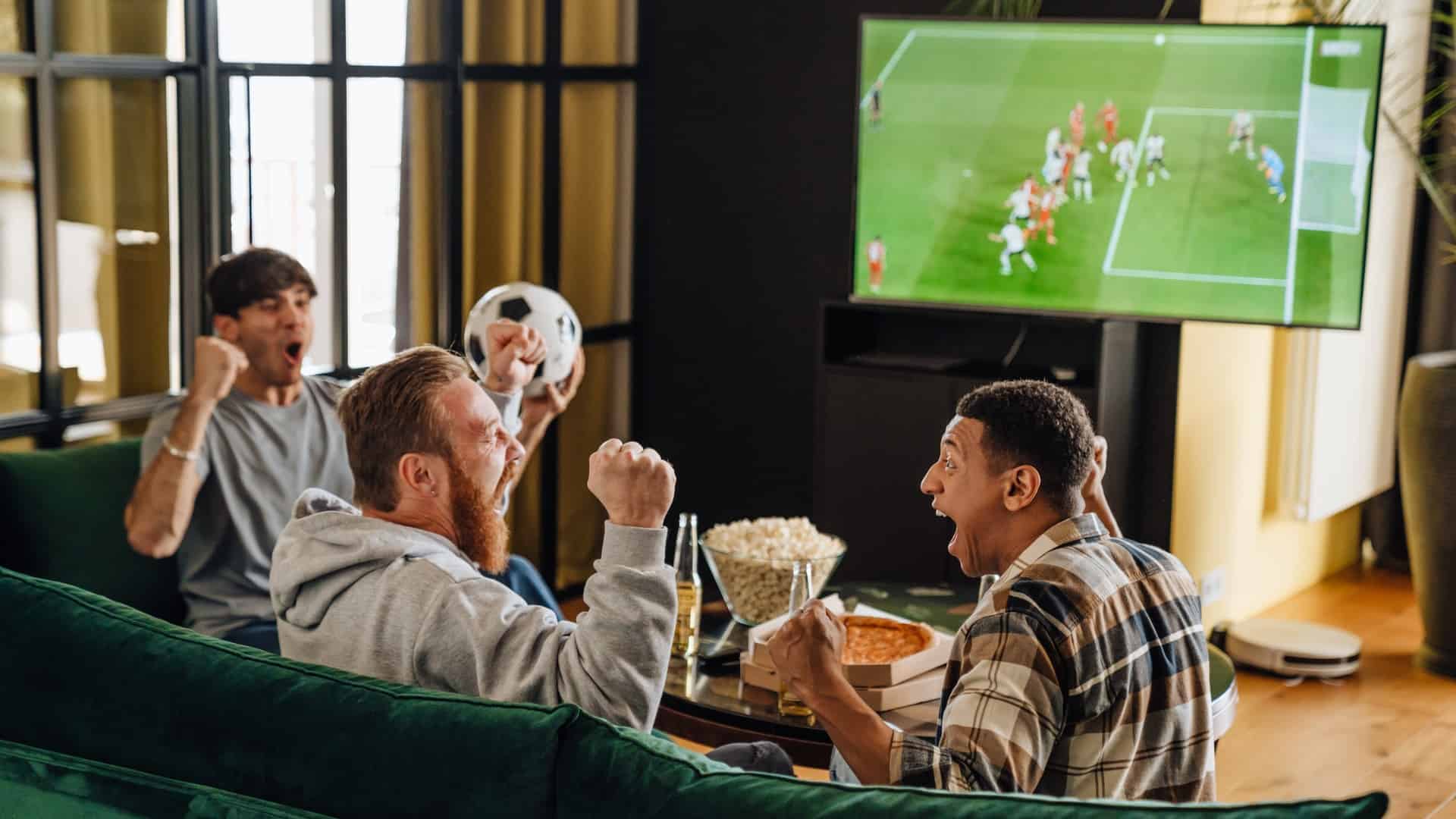 men cheering on football team