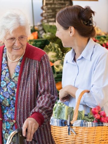 Elderly and middle aged woman grocery shopping