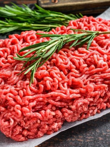 Raw ground beef on a square plate.