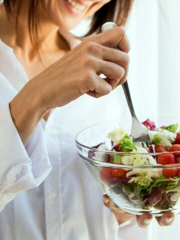 Woman eating a salad.