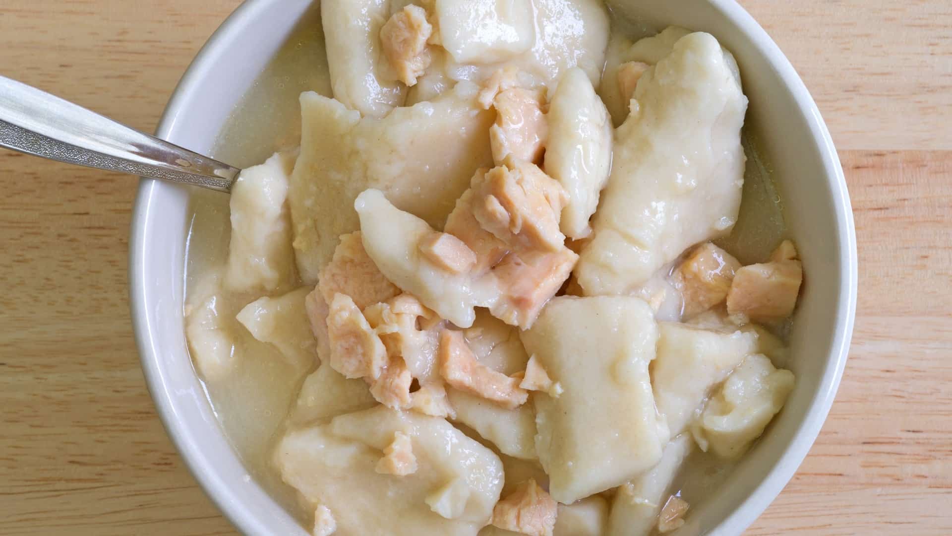 chicken and dumplings in a white bowl