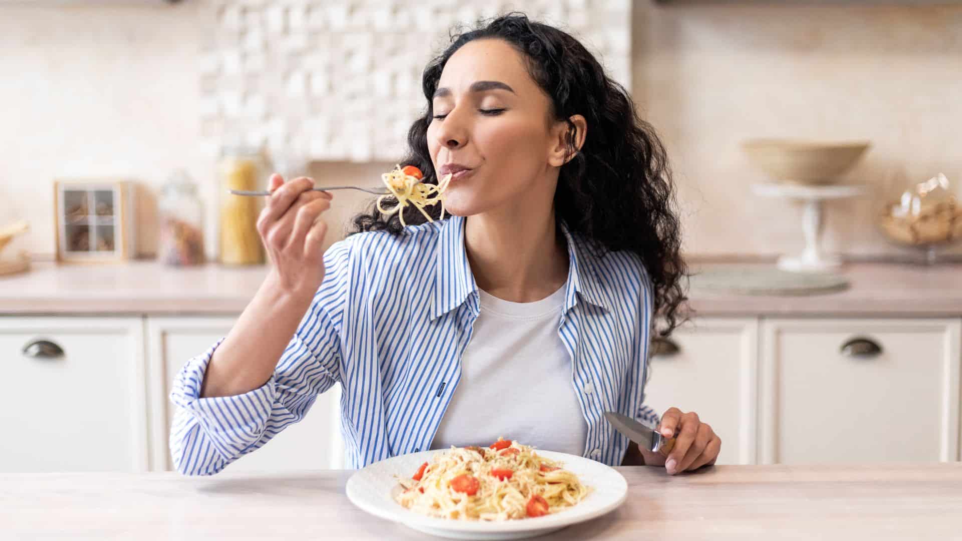 woman eating alone pasta