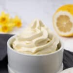 Lemon buttercream frosting in a cup.
