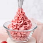 Piping Raspberry buttercream frosting.