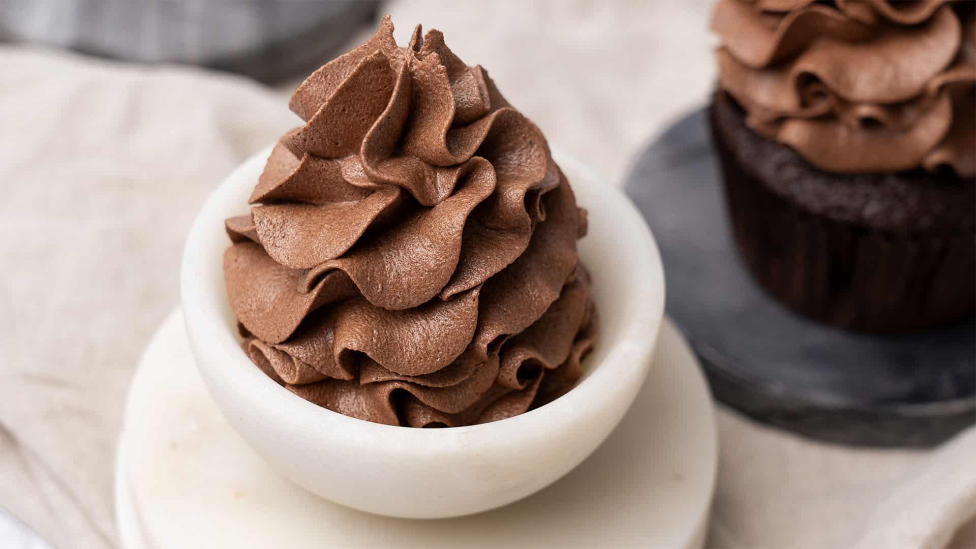 Chocolate buttercream frosting on cupcakes.