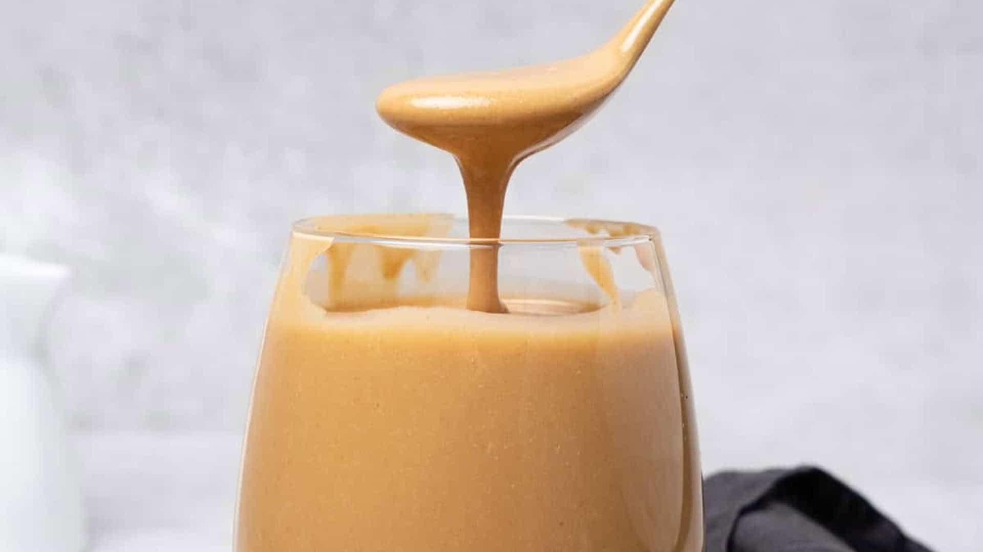 hazelnut butter dripping off of a spoon