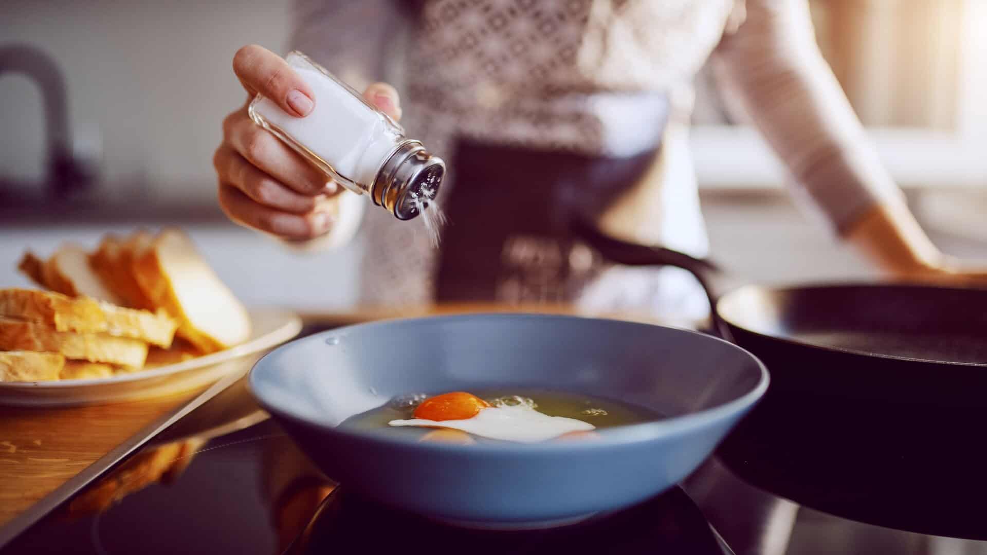 adding salt to a soup