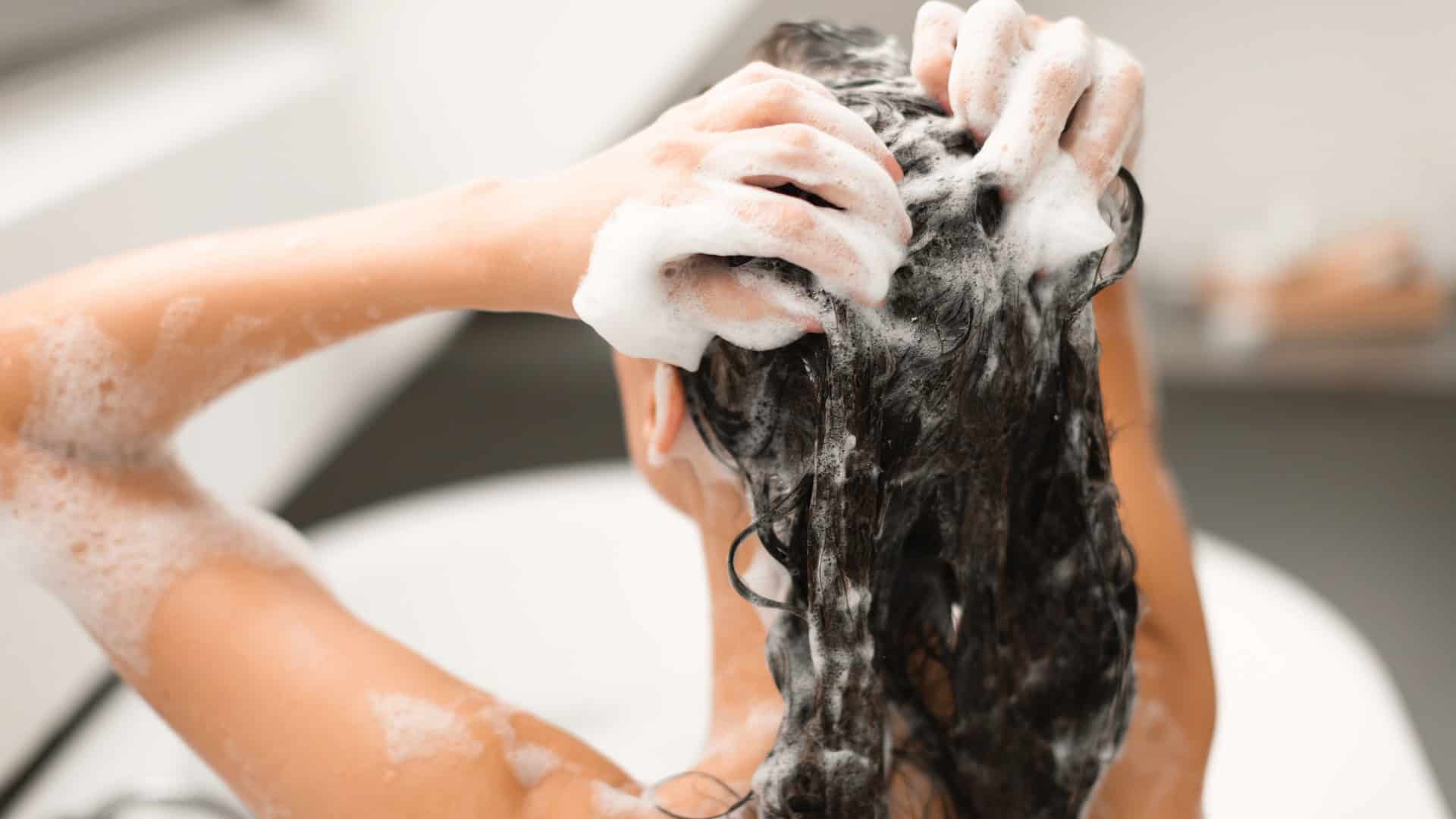 woman washing hair with shampoo