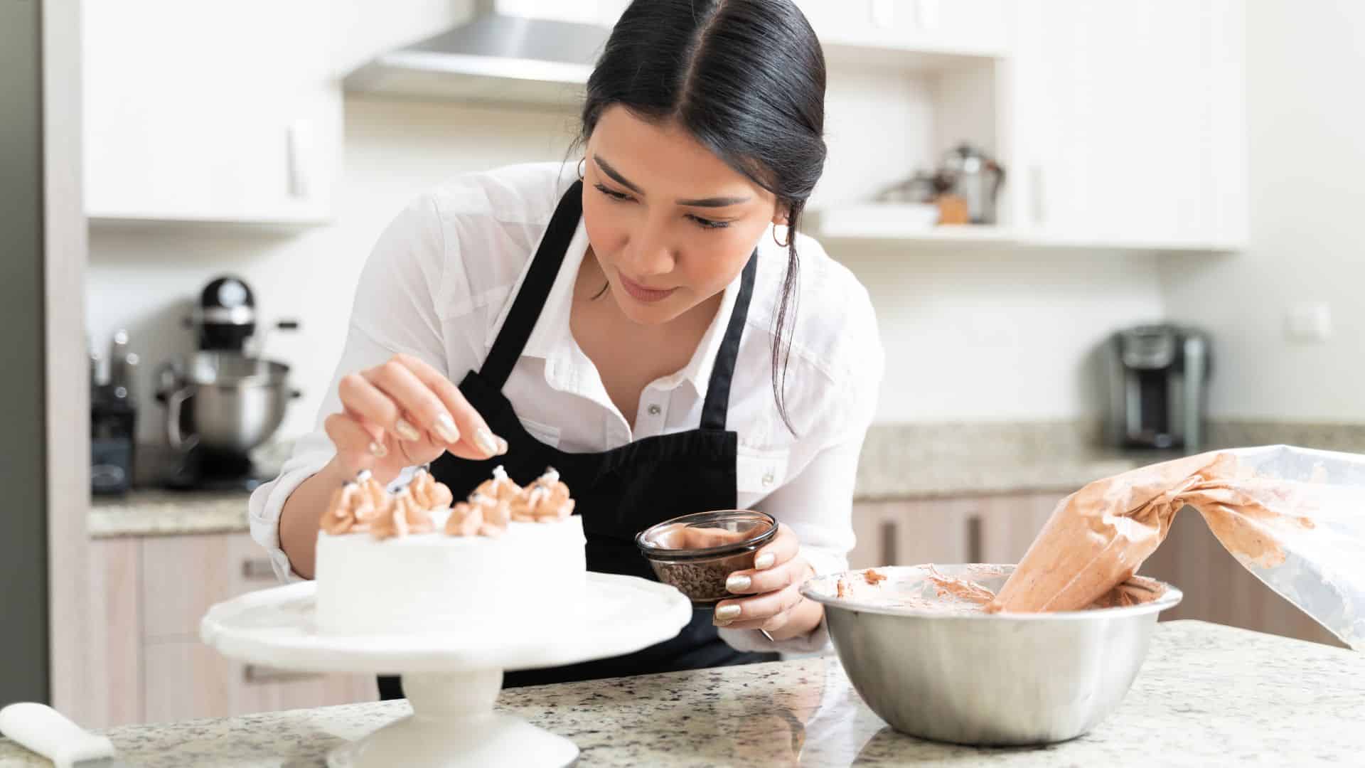 woman decorating cake.