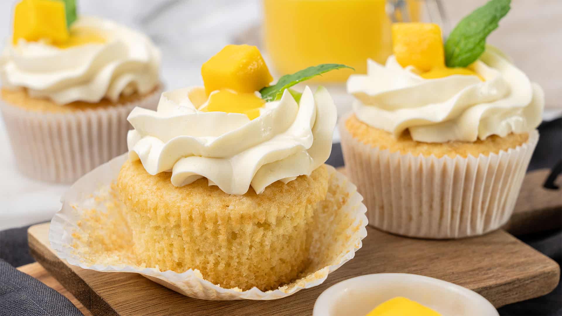Mango cupcake on a cutting board.