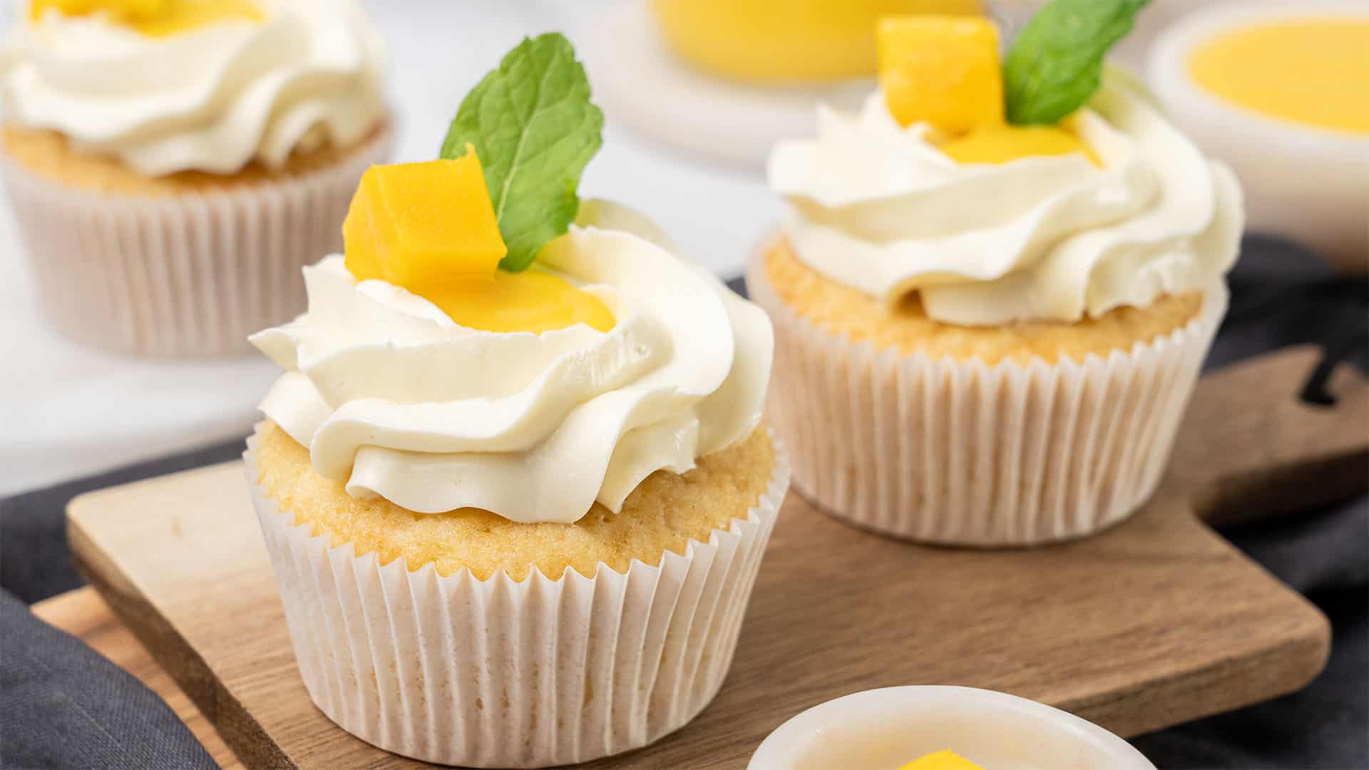 Mango cupcake on a cutting board.