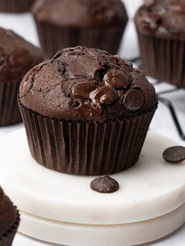 Double chocolate muffins on a cutting board.